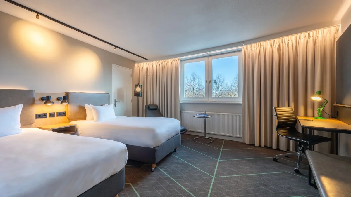 Twin room with two beds and a desk